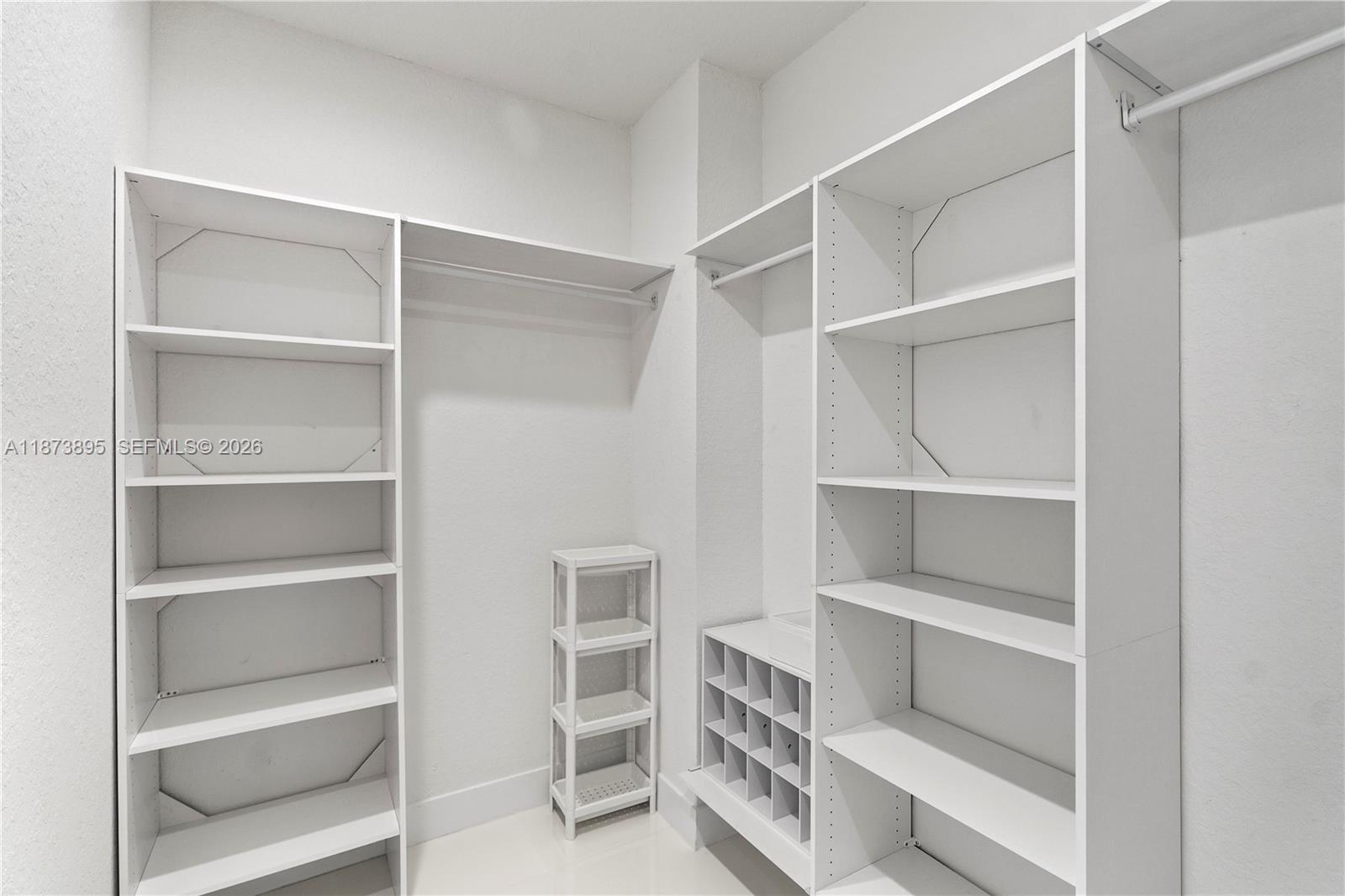 14841 Southwest 39th Terrace Miami, FL 33185 - Photo 38 of 57 a view of walk in closet with empty racks