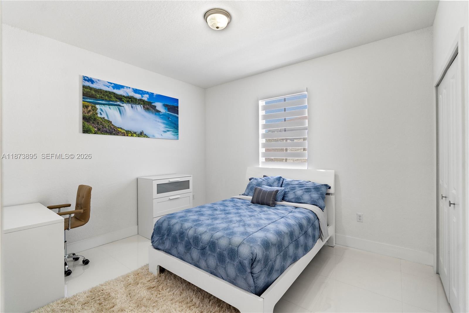 14841 Southwest 39th Terrace Miami, FL 33185 - Photo 42 of 57 a bedroom with a bed and a desk