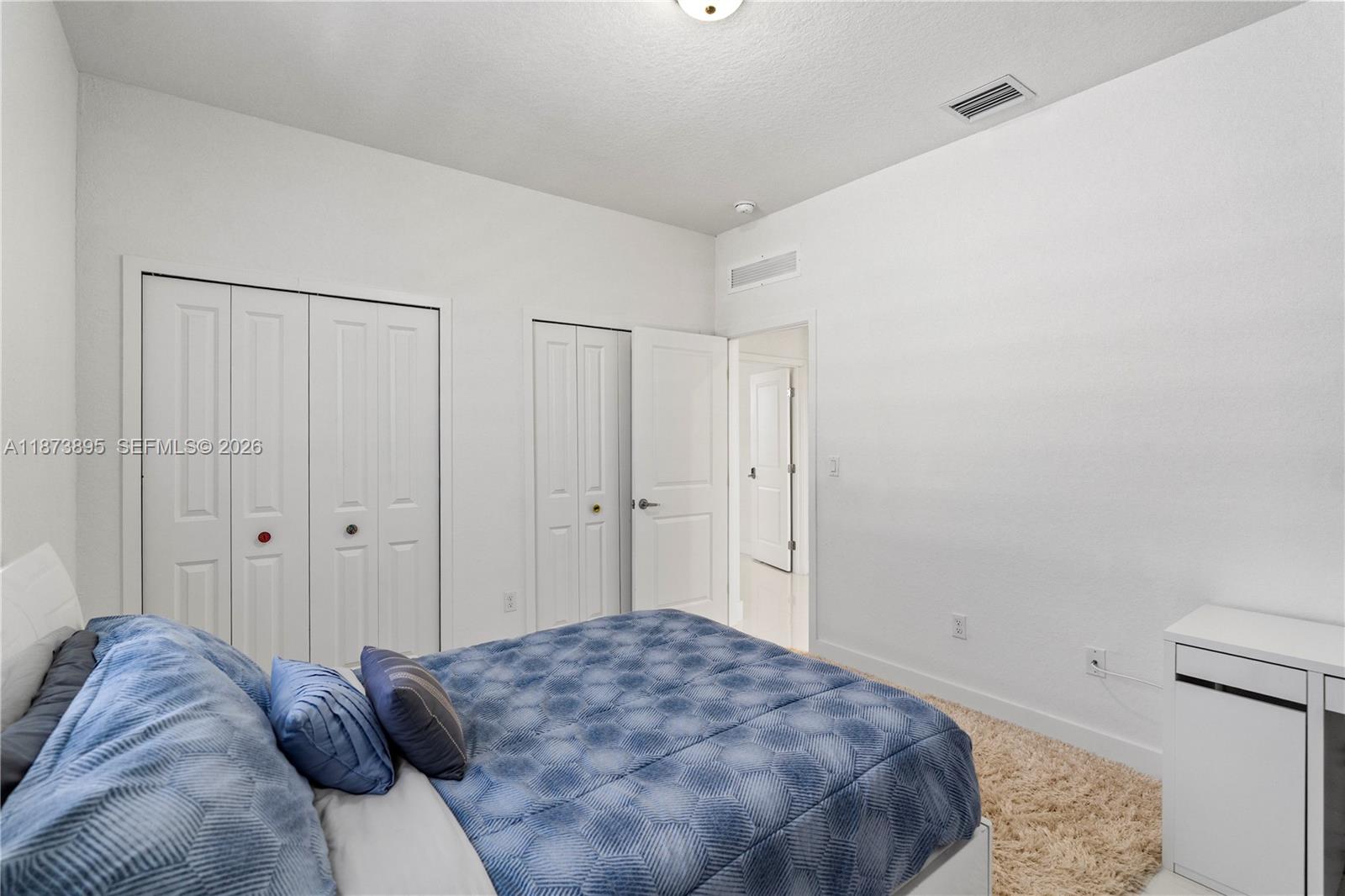 14841 Southwest 39th Terrace Miami, FL 33185 - Photo 43 of 57 a bedroom with a bed and a closet