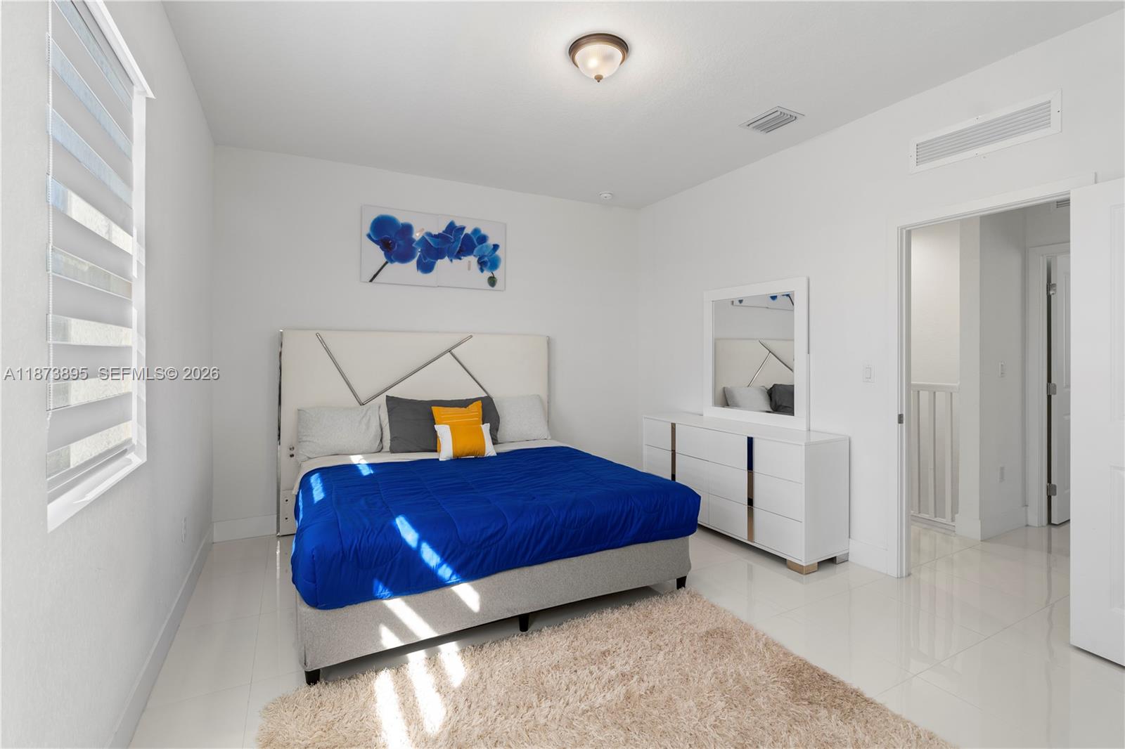 14841 Southwest 39th Terrace Miami, FL 33185 - Photo 44 of 57 a bedroom with a bed and a window