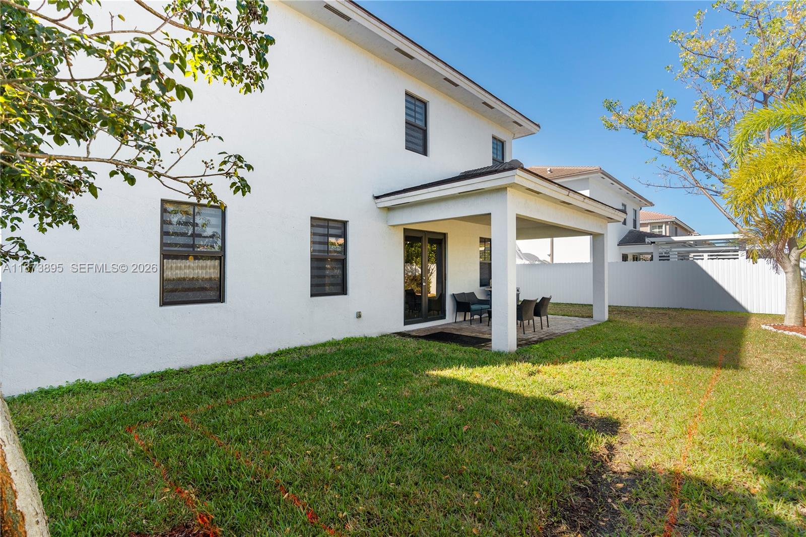 14841 Southwest 39th Terrace Miami, FL 33185 - Photo 51 of 57 a view of a yard in front of a house with plants and large tree