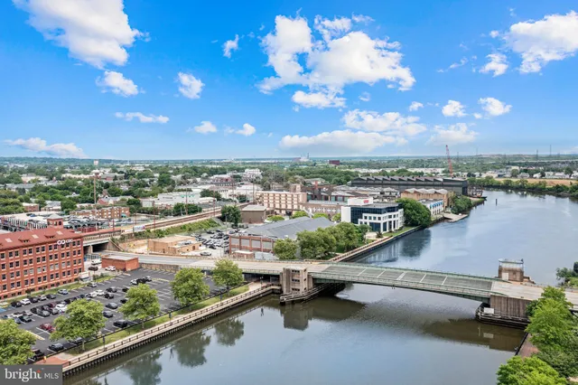 a view of a hallway with wooden floor and entryway
