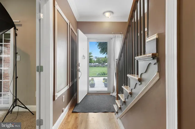 a living room with furniture a flat screen tv and a large window