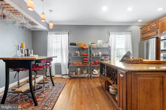 a kitchen with kitchen island granite countertop a stove top oven a sink and a refrigerator