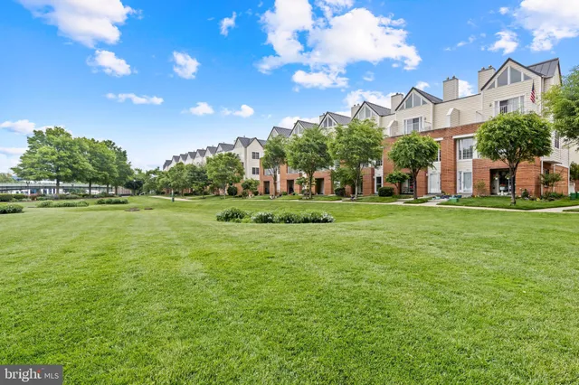 a backyard of a house with lots of green space and fountain