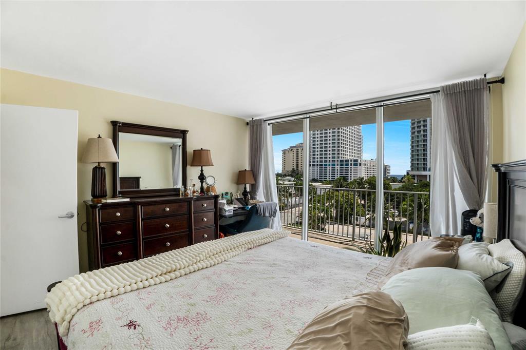 524 Orton Avenue, Unit 604 Fort Lauderdale, FL 33304 - Photo 11 of 24 a bedroom with a bed and glass top door