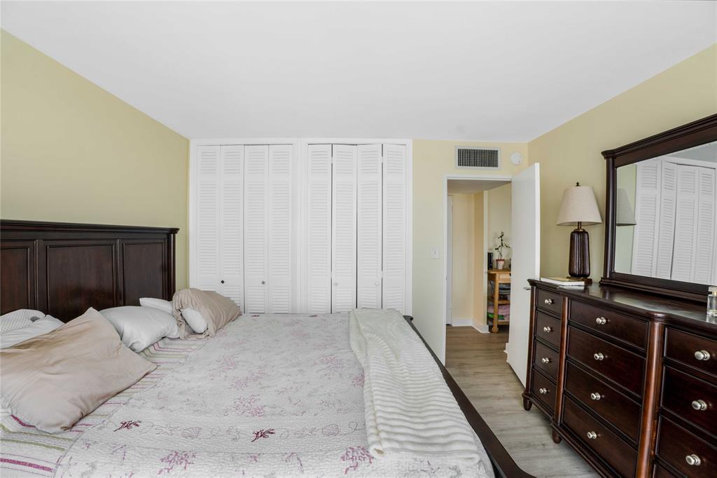 524 Orton Avenue, Unit 604 Fort Lauderdale, FL 33304 - Photo 12 of 24 a large bedroom with a bed and a dresser
