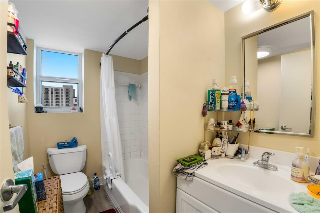 524 Orton Avenue, Unit 604 Fort Lauderdale, FL 33304 - Photo 13 of 24 a bathroom with a sink mirror vanity and toilet