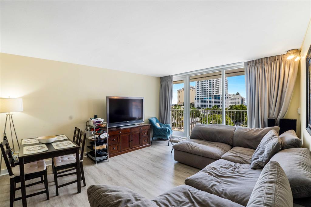 524 Orton Avenue, Unit 604 Fort Lauderdale, FL 33304 - Photo 6 of 24 a living room with furniture and a flat screen tv