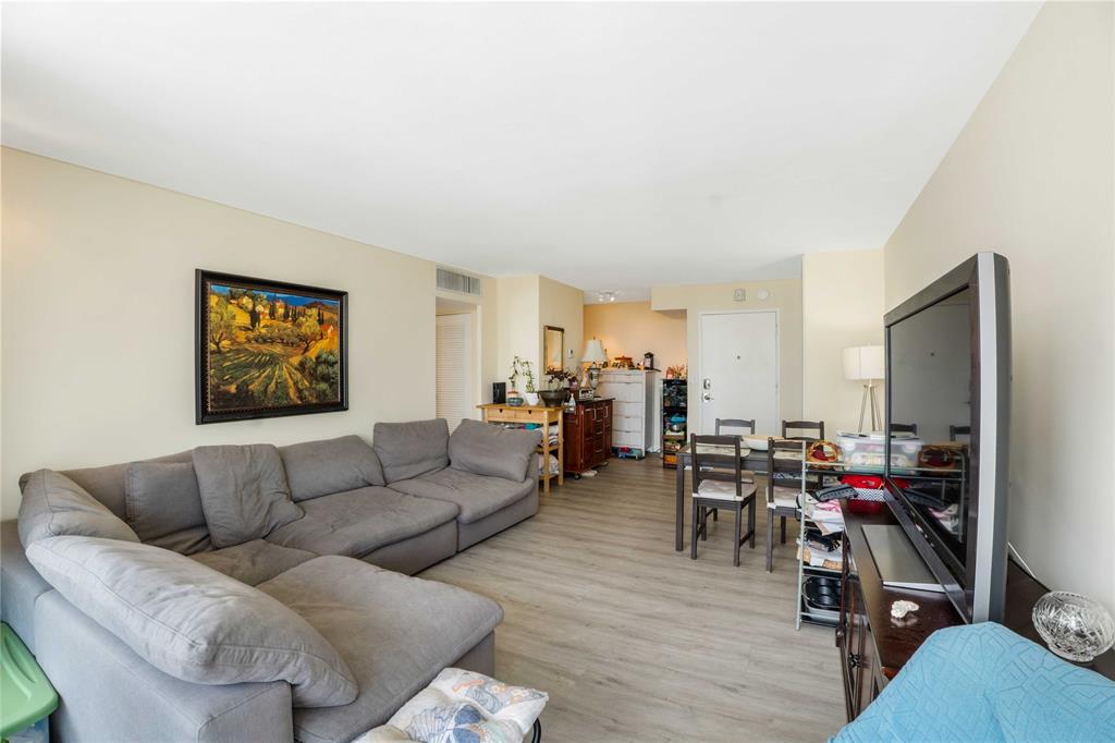 524 Orton Avenue, Unit 604 Fort Lauderdale, FL 33304 - Photo 7 of 24 a living room with furniture and a flat screen tv