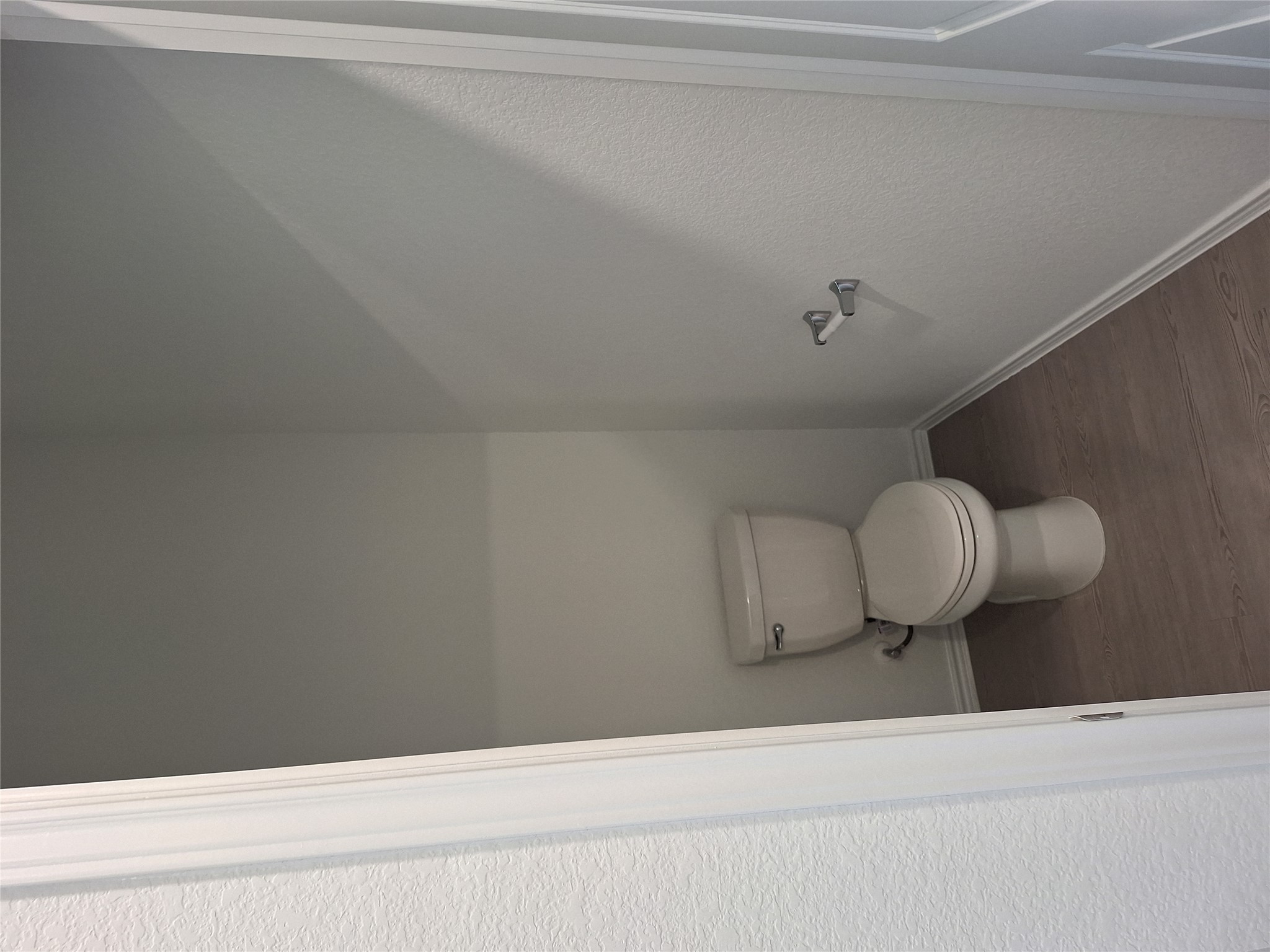 18001 Prairie Falcon Way Pflugerville, TX 78660 - Photo 26 of 38 Powder room featuring a single toilet with a dual-flush mechanism, wood-finish flooring, and white baseboards