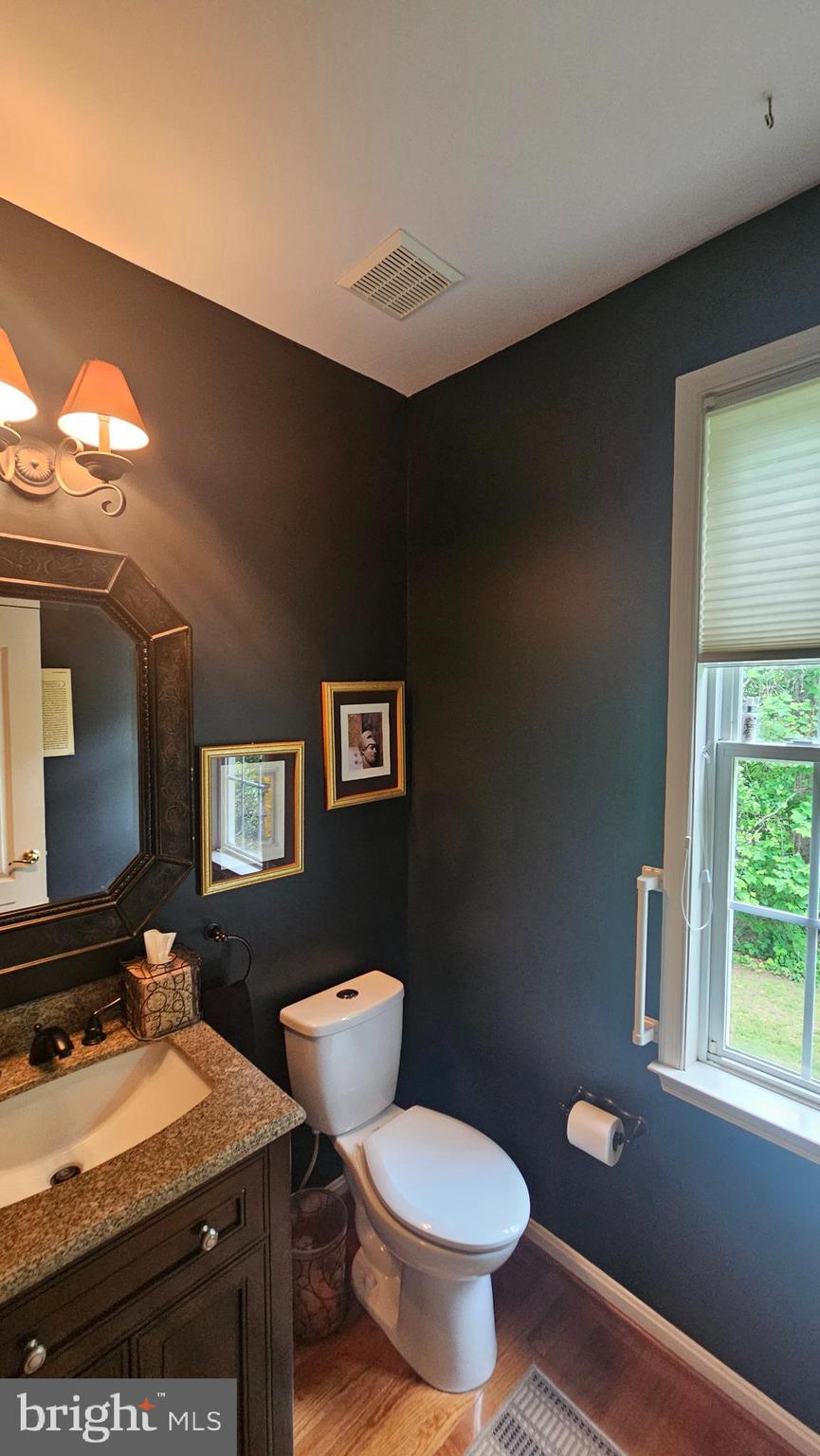 6107 Traceys Overlook Road Tracys Landing, MD 20779 - Photo 16 of 67 a bathroom with a toilet sink and mirror