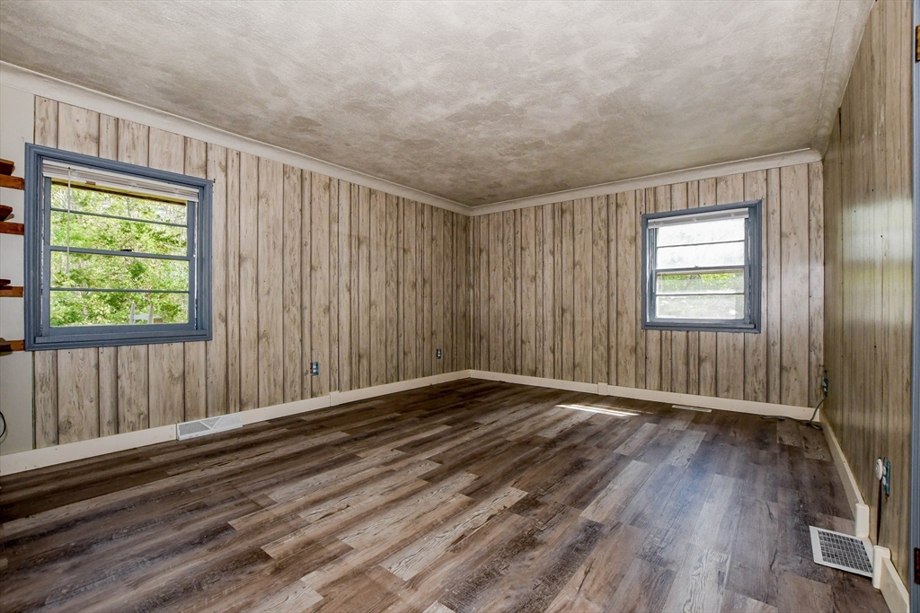 6 Gilbert Way Wareham, MA 02571 - Photo 22 of 41 a view of an empty room with wooden floor and a window