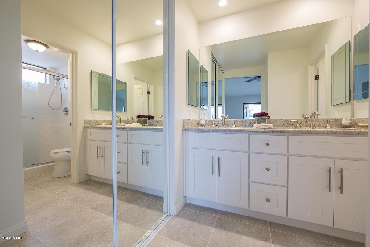 4265 Laurelhurst Road Moorpark, CA 93021 - Photo 25 of 47 a spacious bathroom with a granite countertop sink a toilet and a mirror