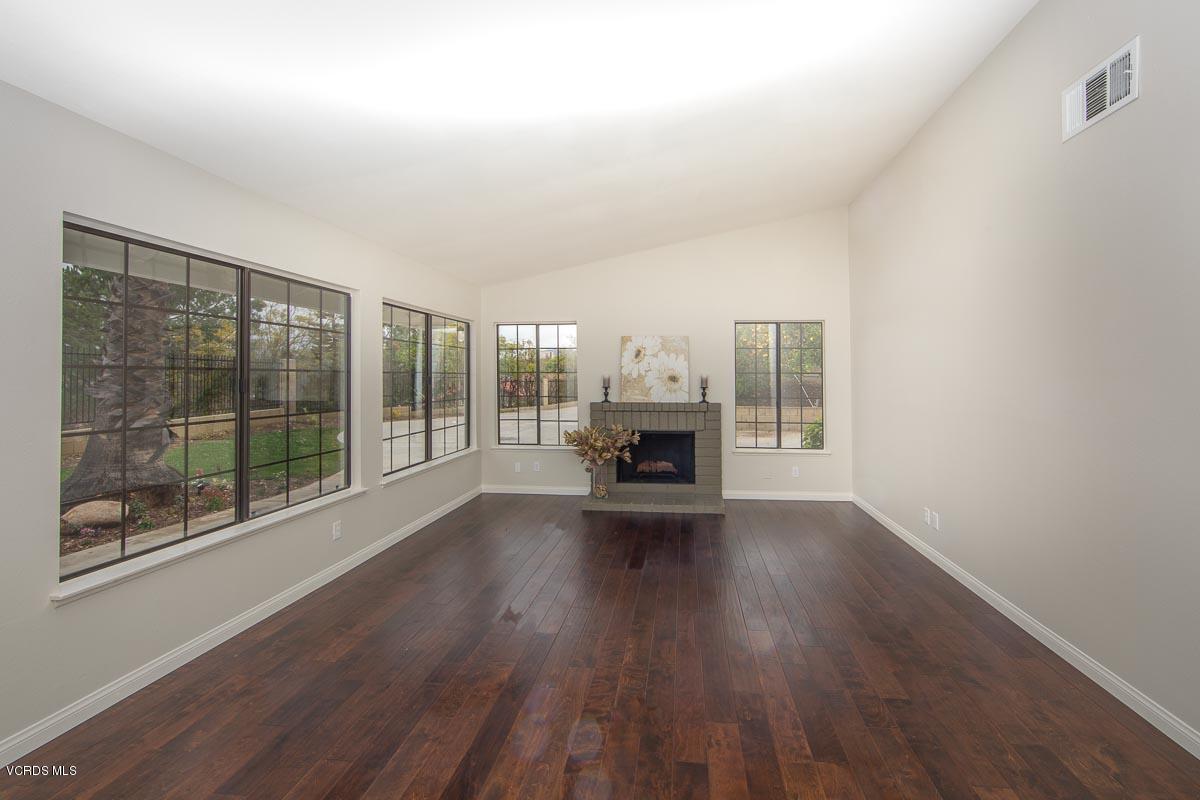 4265 Laurelhurst Road Moorpark, CA 93021 - Photo 5 of 47 a view of empty room with wooden floor and fireplace