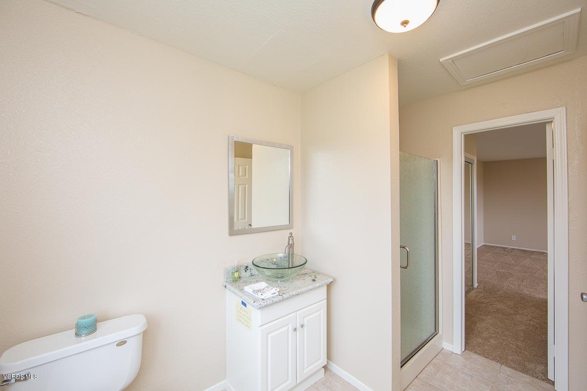 4265 Laurelhurst Road Moorpark, CA 93021 - Photo 41 of 47 a bathroom with a toilet a sink a mirror and vanity