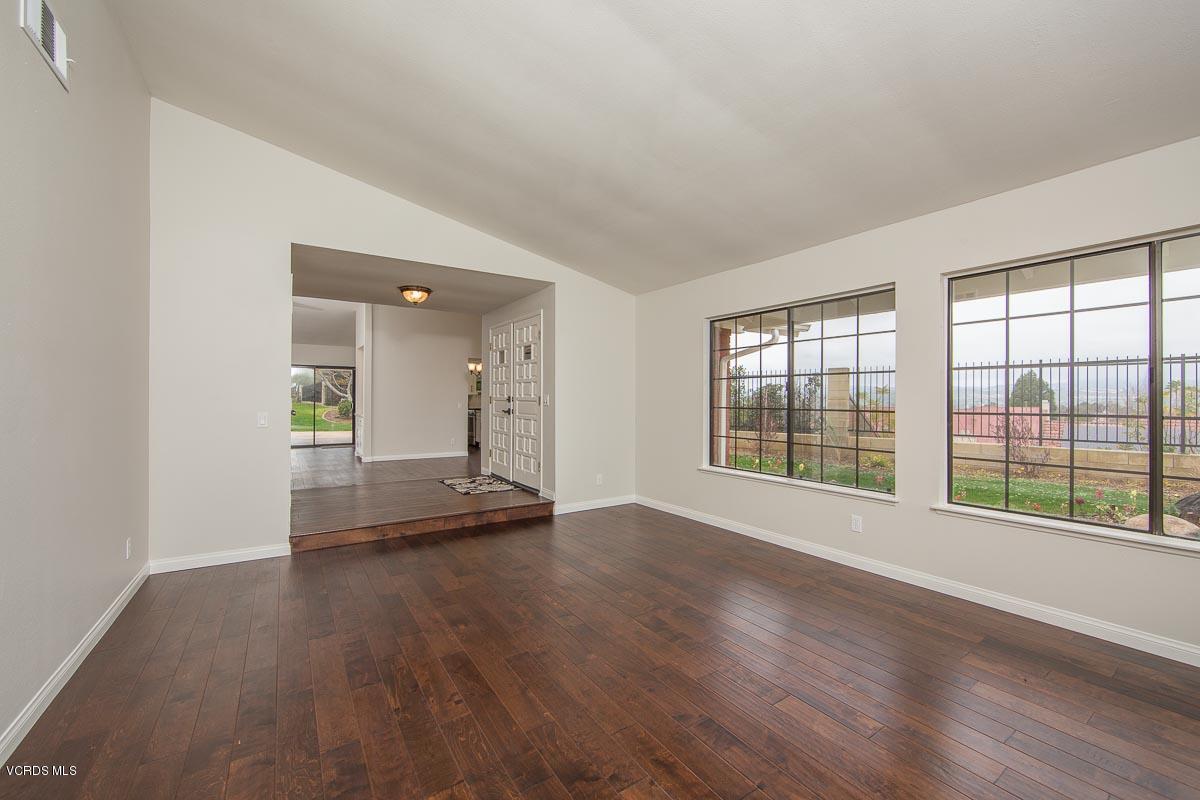 4265 Laurelhurst Road Moorpark, CA 93021 - Photo 6 of 47 a view of an empty room with wooden floor and a window