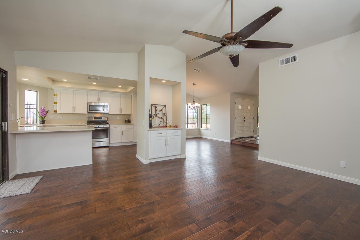 4265 Laurelhurst Road Moorpark, CA 93021 - Photo 10 of 47 a view of a big room with wooden floor and a kitchen