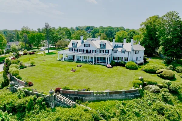 an aerial view of a house with swimming pool garden and outdoor seating