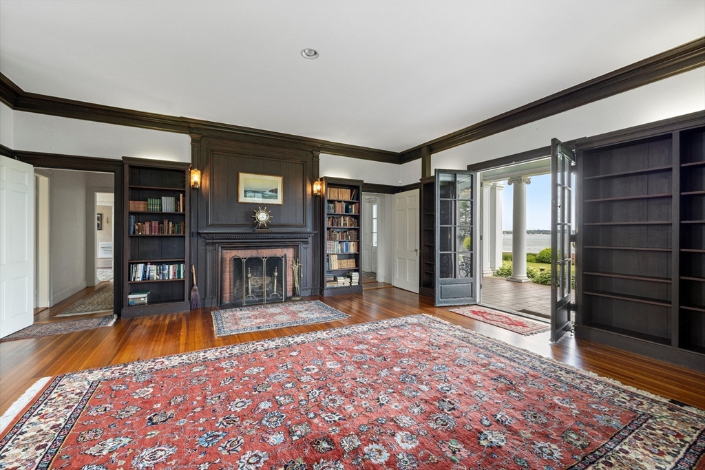 4 Broadmere Way Marblehead, MA 01945 - Photo 14 of 31 a living room with a fireplace furniture and a rug