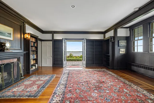a view of a hallway with wooden floor and a fireplace