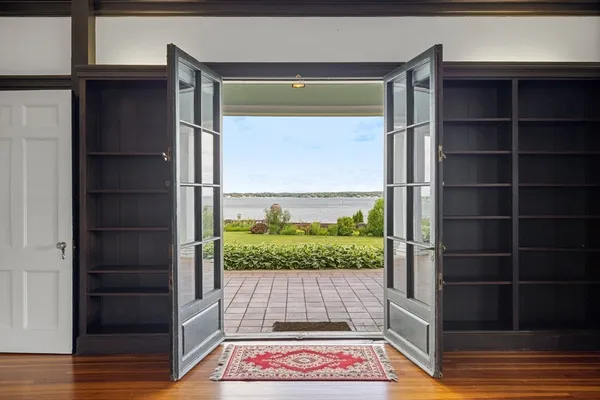 a view of a balcony with wooden floor and a potted plant