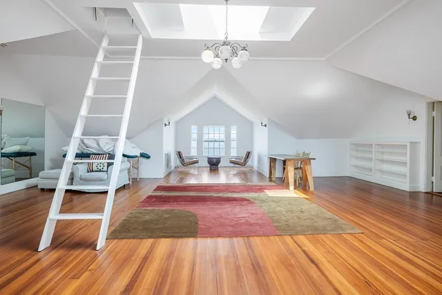 a living room with a floor to ceiling window and furniture