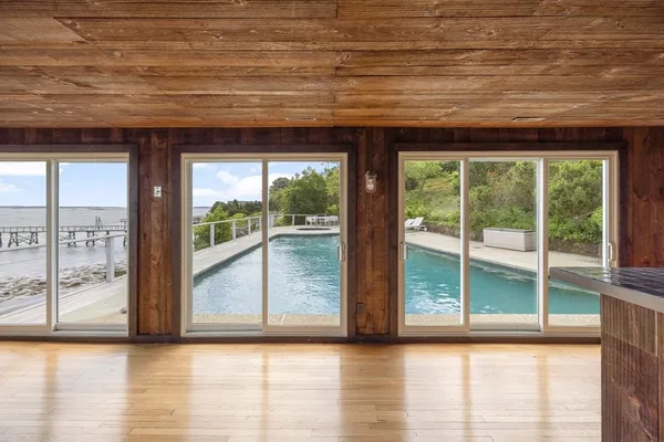 a view of a room with wooden floor and a large window