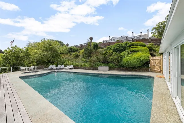 a view of a backyard with swimming pool