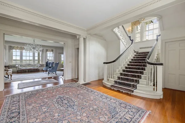 a view of an entryway with wooden floor and a rug