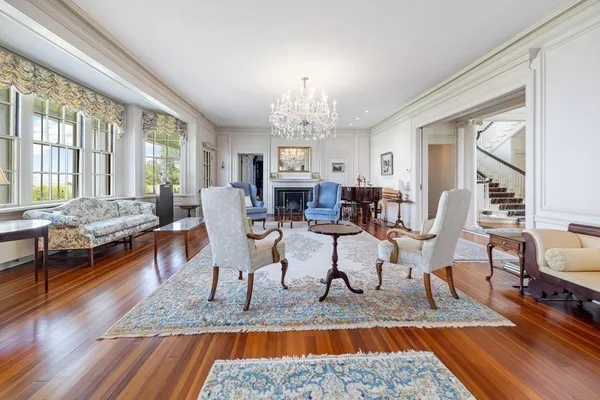 a living room with fireplace furniture and a chandelier