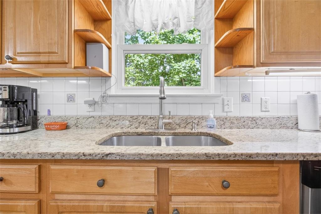 3771 Castleberry Road Cumming, GA 30040 - Photo 20 of 69 a kitchen with granite countertop a sink and a window