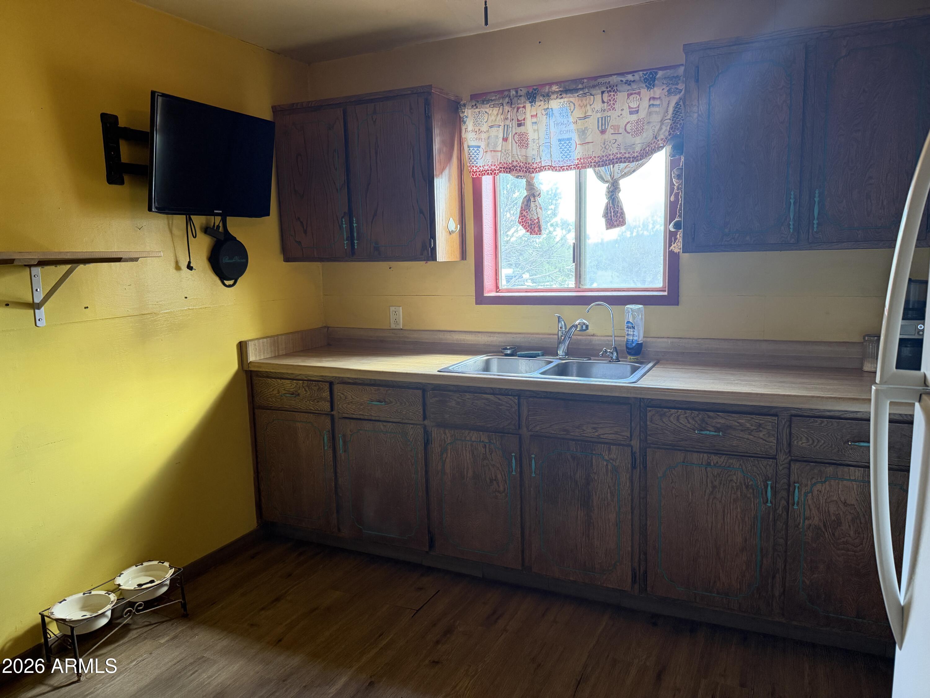 1 Hideaway Road Ash Fork, AZ 86320 - Photo 7 of 43 a kitchen with a sink and wooden cabinets