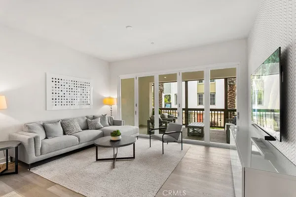 a living room with furniture and a floor to ceiling window
