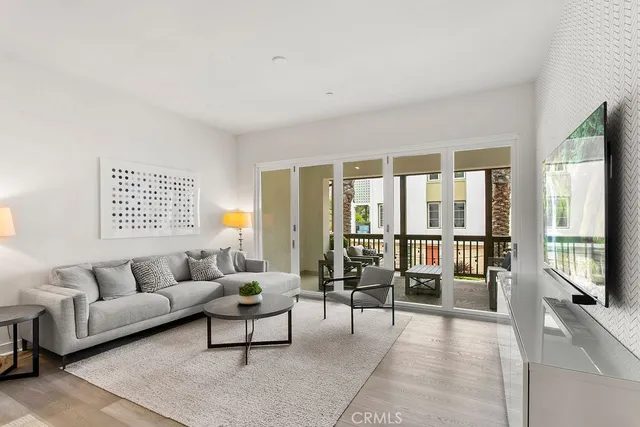 a living room with furniture and a floor to ceiling window
