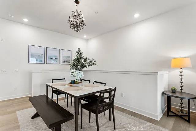 a dining room with furniture and chandelier