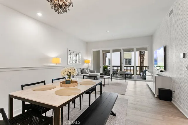 a view of a a dining room with furniture window and wooden floor