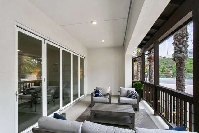 a living room with furniture and large windows