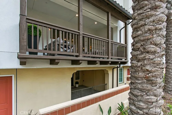 a view of balcony with two chairs and wooden fence