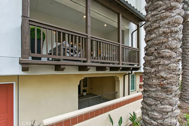 a view of balcony with two chairs and wooden fence