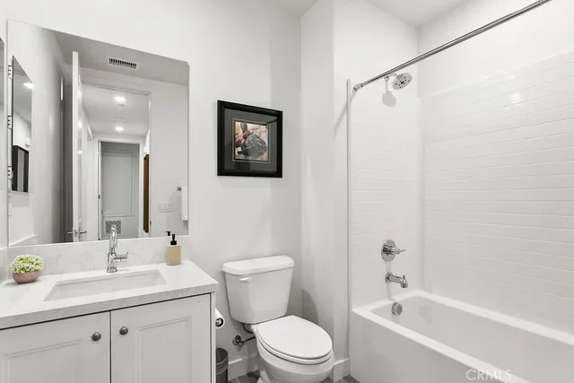a bathroom with a toilet sink and shower