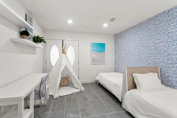 a room with a bed and a chandelier