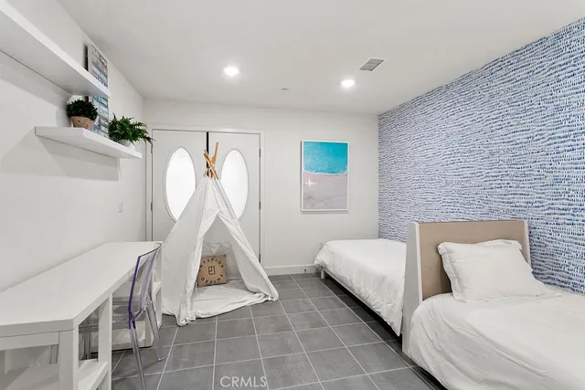 a room with a bed and a chandelier