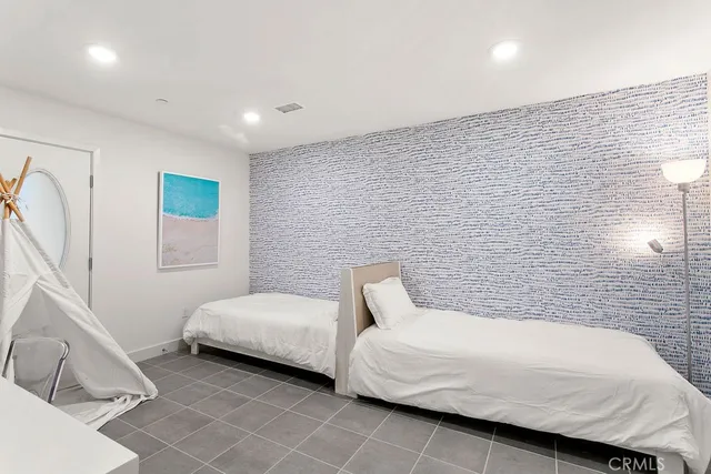 a bedroom with a bed and a couch