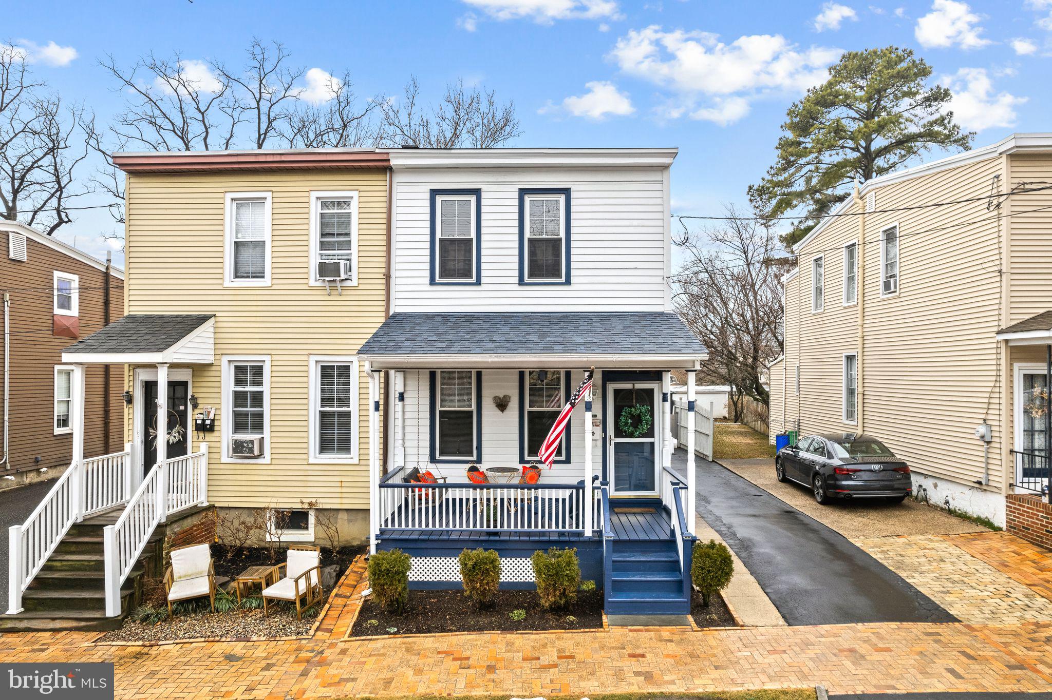 a view of a house with wooden deck and furniture