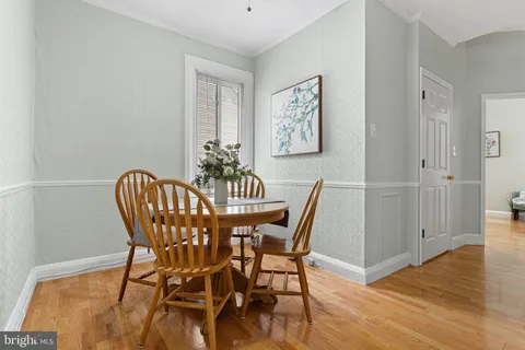 a view of a room that has a table and chairs in it