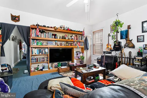 a view of a kitchen with fridge and workspace