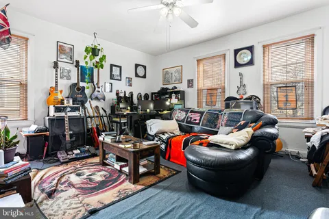a room with stainless steel appliances a stove a refrigerator a sink a stove and white cabinets