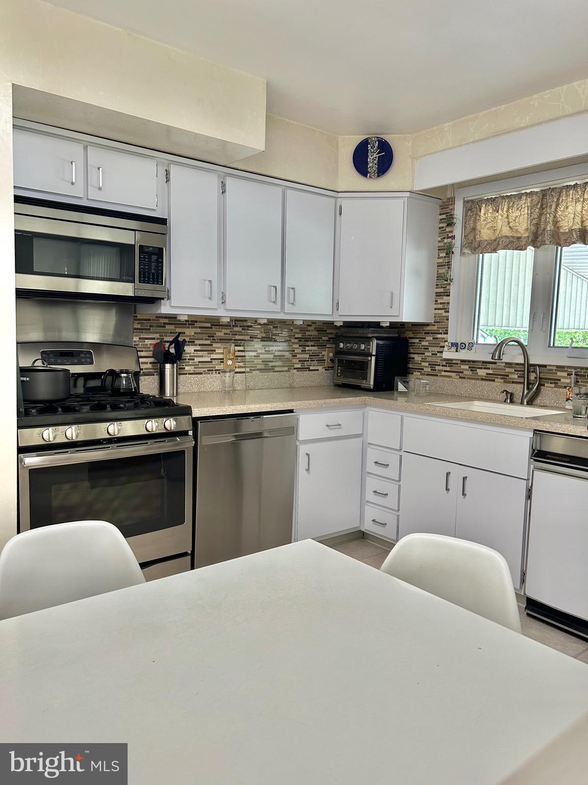1017 Alpena Road Philadelphia, PA 19115 - Photo 10 of 30 a kitchen with a sink stove and cabinets