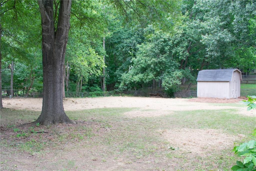 1537 Rogers Road Graham, NC 27253 - Photo 22 of 23 Fenced Backyard With Storage Building